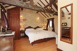 Oak beams and sonework in the large bedroom