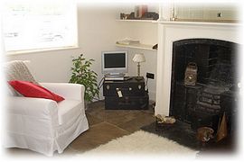 Lounge with flagstone floor and open hearth