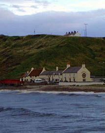 The Ship Inn below the cottages on the cliff