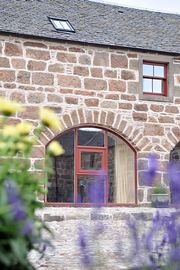 Simmental window onto cobbled courtyard  	 