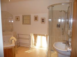 Bathroom with whirlpool bath and shower