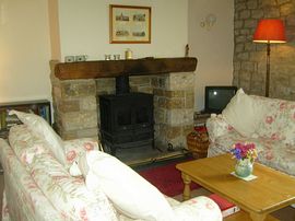 Sitting room with beamed fireplace