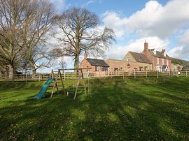 Large play area for children in front of the cottage