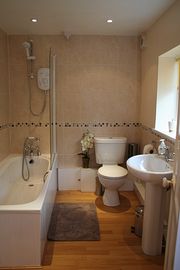 Stylish bathroom with bath, shower, washbasin and toilet.
