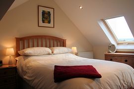 Double bedroom built into the rafters with roof lights which provide a warm natural glow to the room.